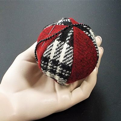 hand-stitching the bead trim onto harris tweed christmas bauble by roses workshop