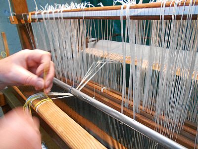 threading the warp through the heddles